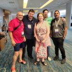 Neil Squire staff members Dale, Gordon, Bev, Joel, and Munesh pose for a photo at ATIA.