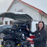 Trina showing her wheelchair lift bringing her wheelchair into her van.