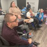 Participants playing games together at an Adaptive Gaming event with Cerebral Palsy Alberta.