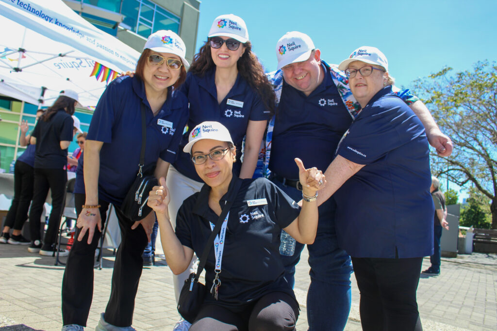 Neil Squire staff Maribeth, Leila, Joanna, Gordon, and Mary-Anne all smile together.