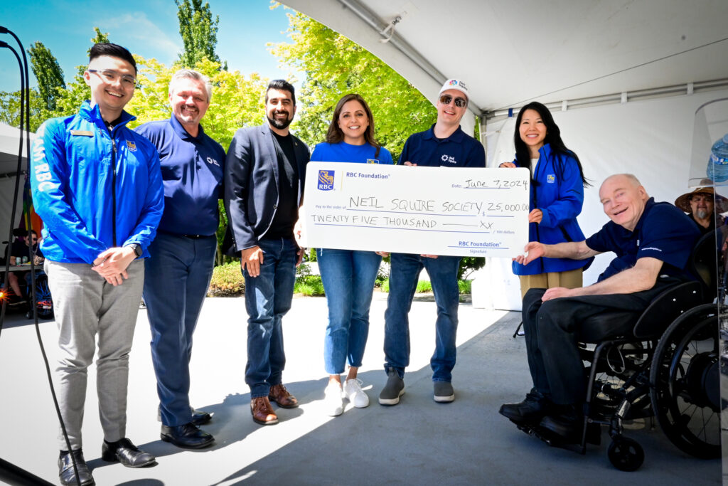 RBC staff presenting a cheque for $25,000, with Neil Squire staff Nate Toevs, Chad Leaman, and executive Gary Birch.