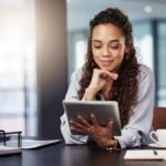 A woman looks at her tablet