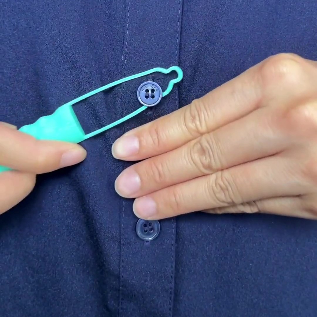 A Button Aid being used to button up a shirt.