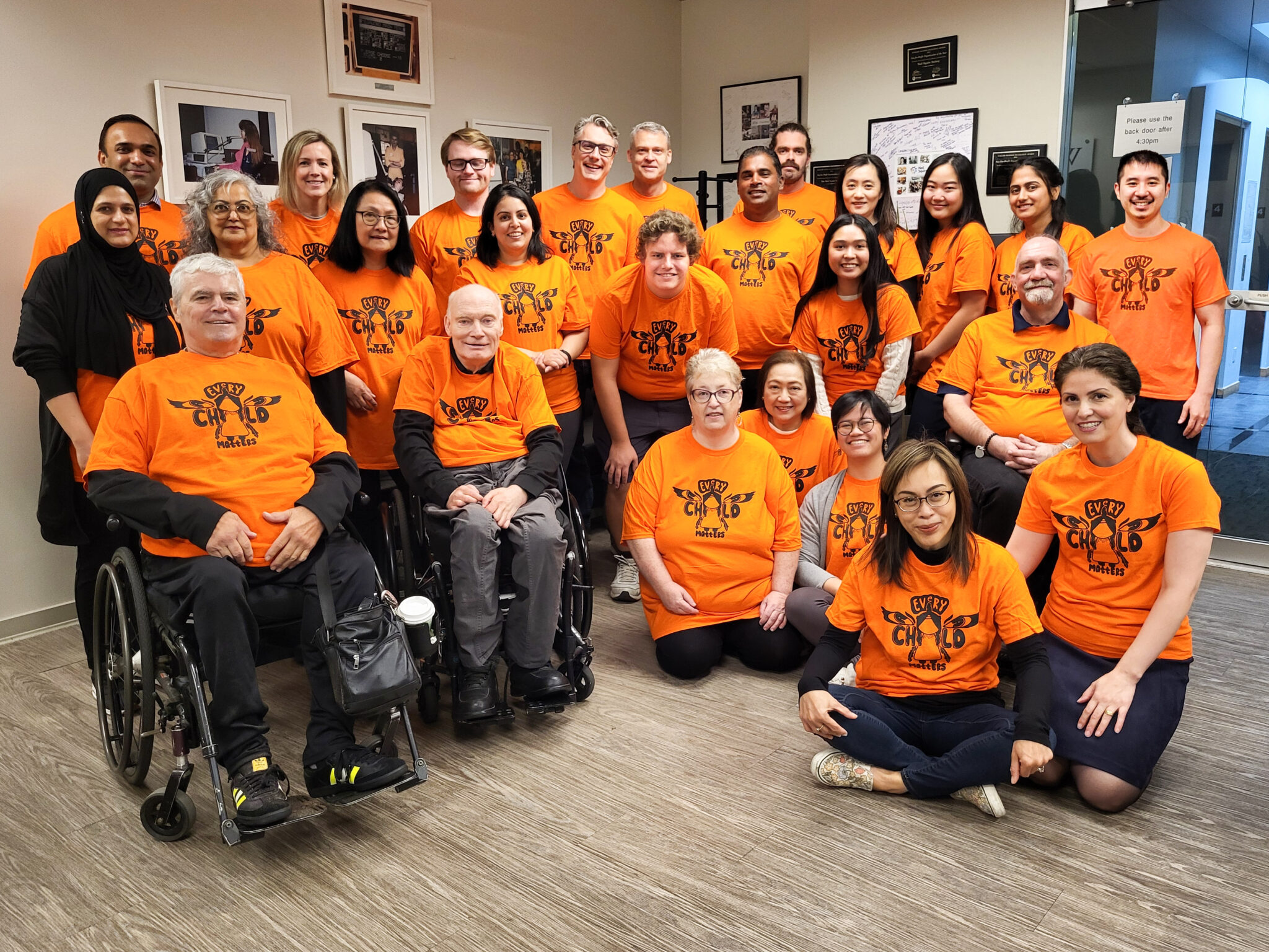 Neil Squire Burnaby office wearing orange shirts