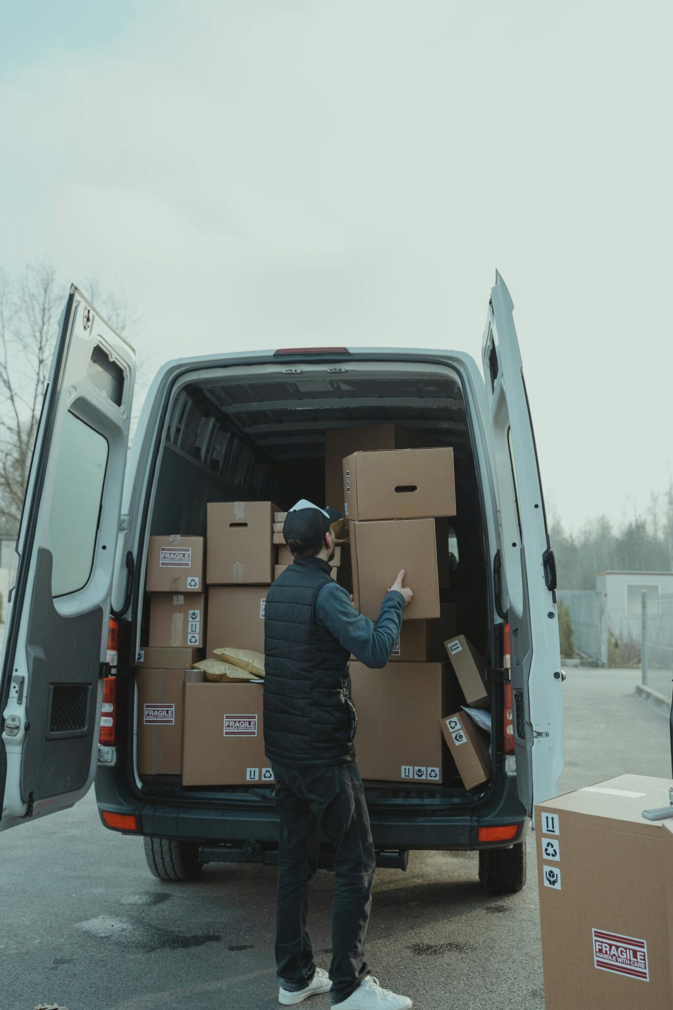 A man unloads boxes from a van.