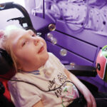 a child with a disability using an adapted bubble blower