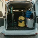 An open van with cleaning tools inside.