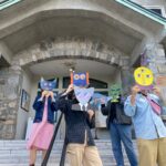 Penticton and District Community Arts Council staff show off masks made by youth.