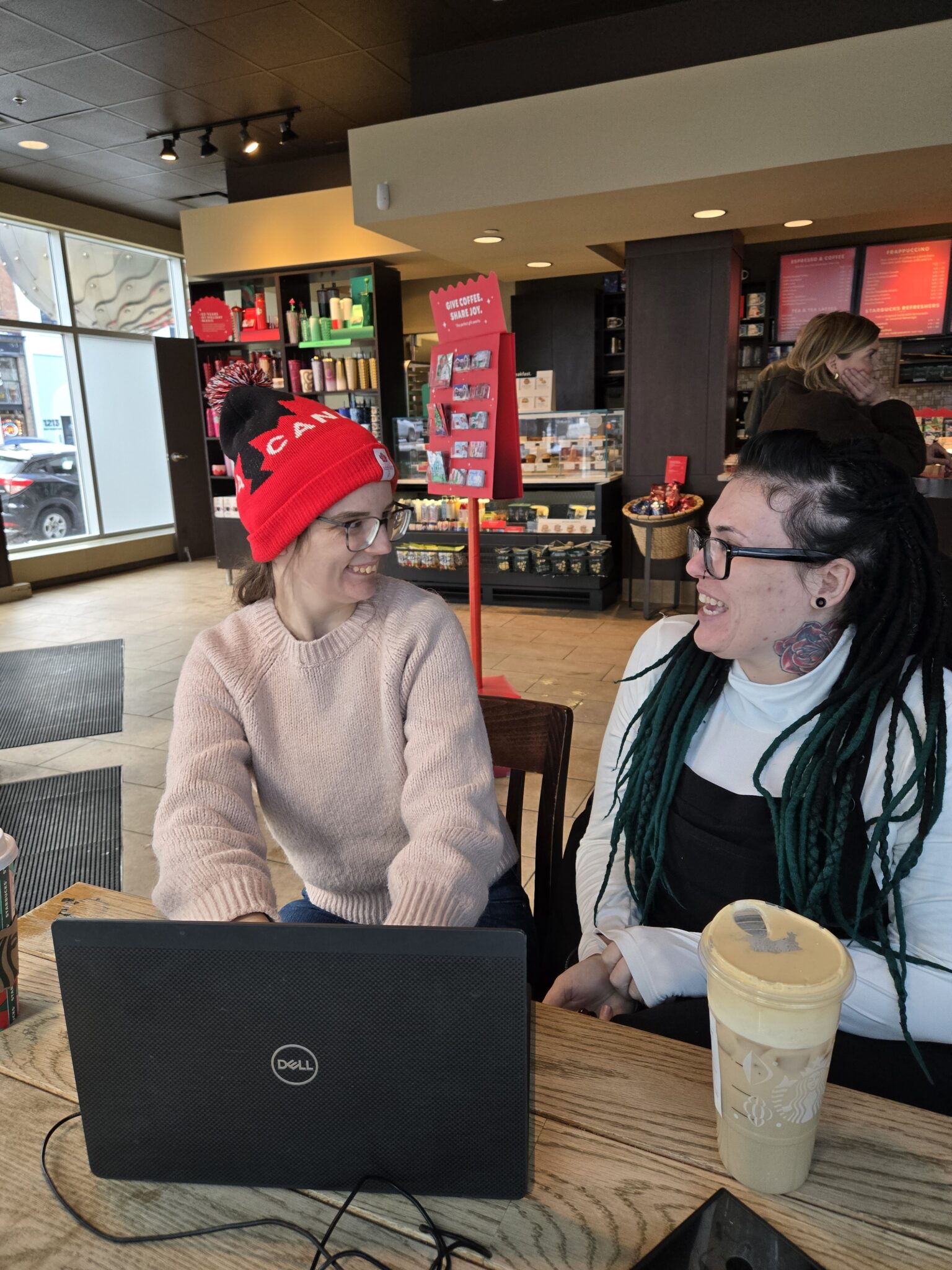 Kennedy (left) talks with Shannel (right) at a cafe.