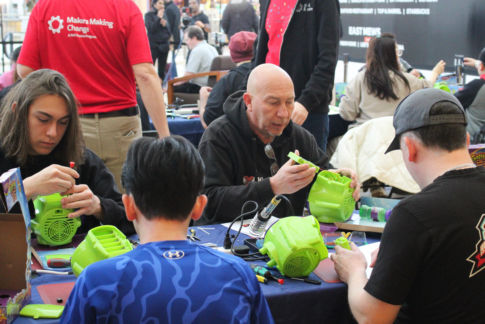 Volunteer makers work on devices at the Holiday Hackathon in November.