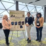 Nikki, Patty, and Julie next to a sign for Cannexus 25.