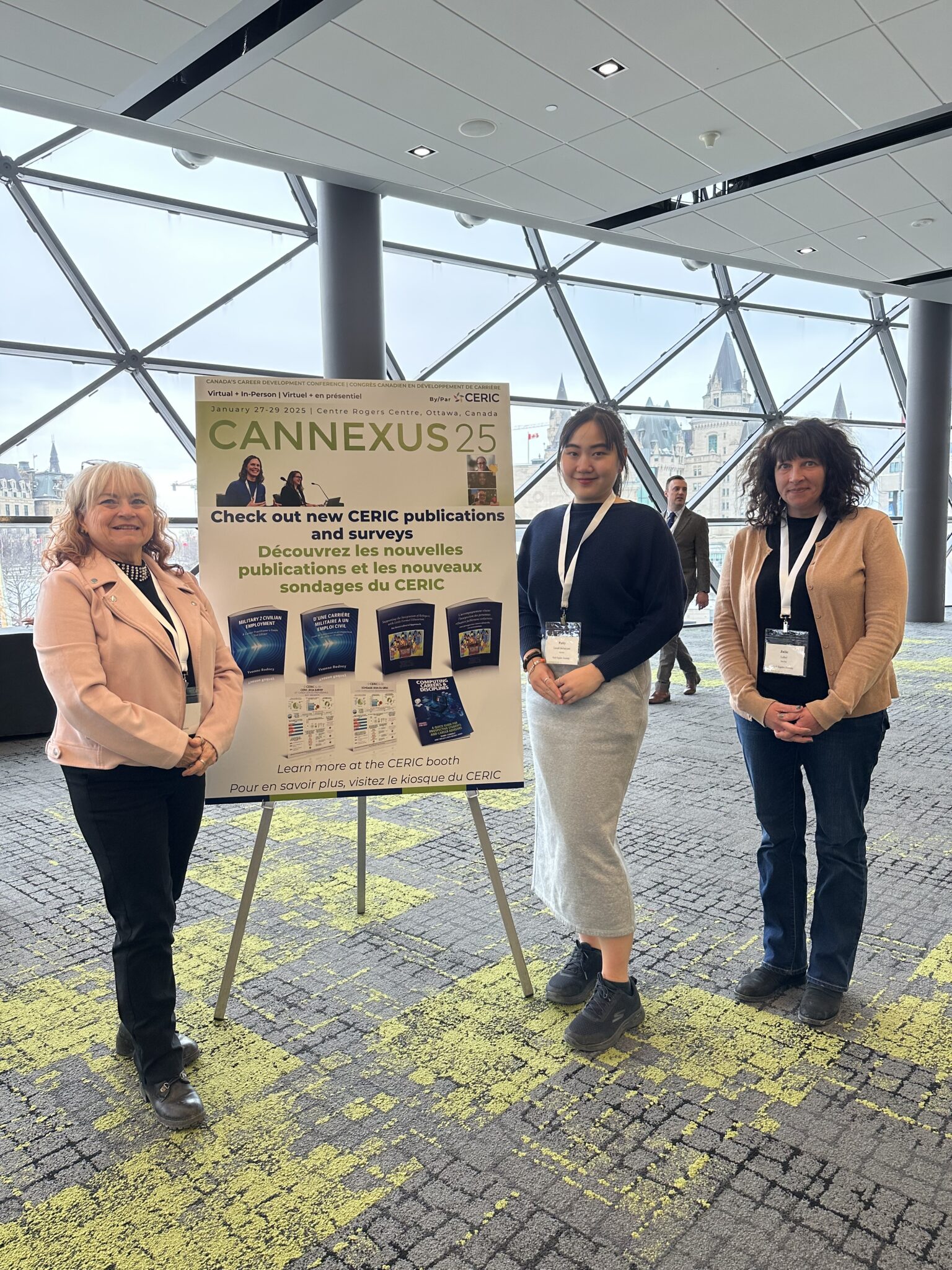 Nikki, Patty, and Julie next to a sign for Cannexus 25.