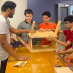 Students at MakerSpace NYC work on the standing desk prototype.