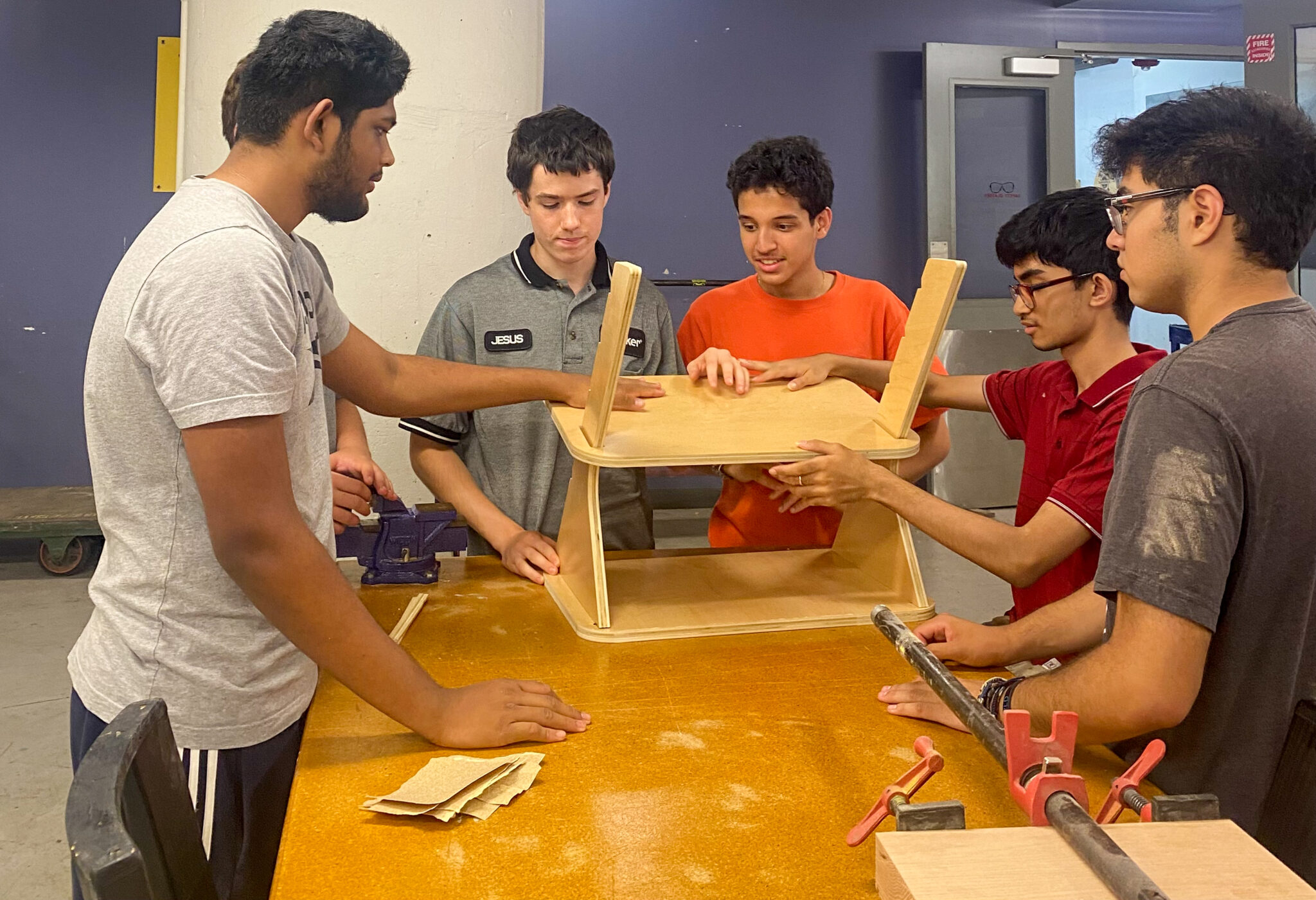 Students at MakerSpace NYC work on the standing desk prototype.