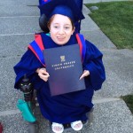 Amelia in her graduation gown, holding her degree.